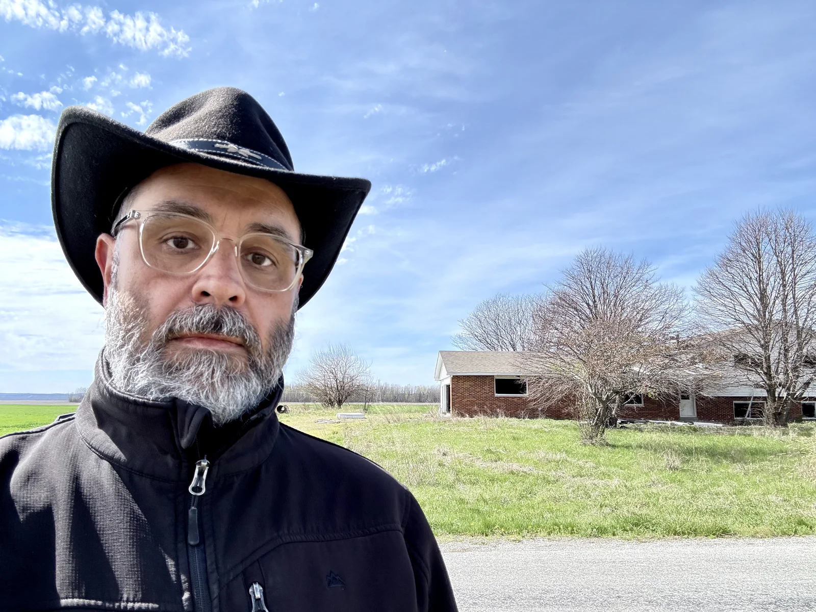 A selfie of me standing on the opposite side of Steppig Rd, with the house in the background.