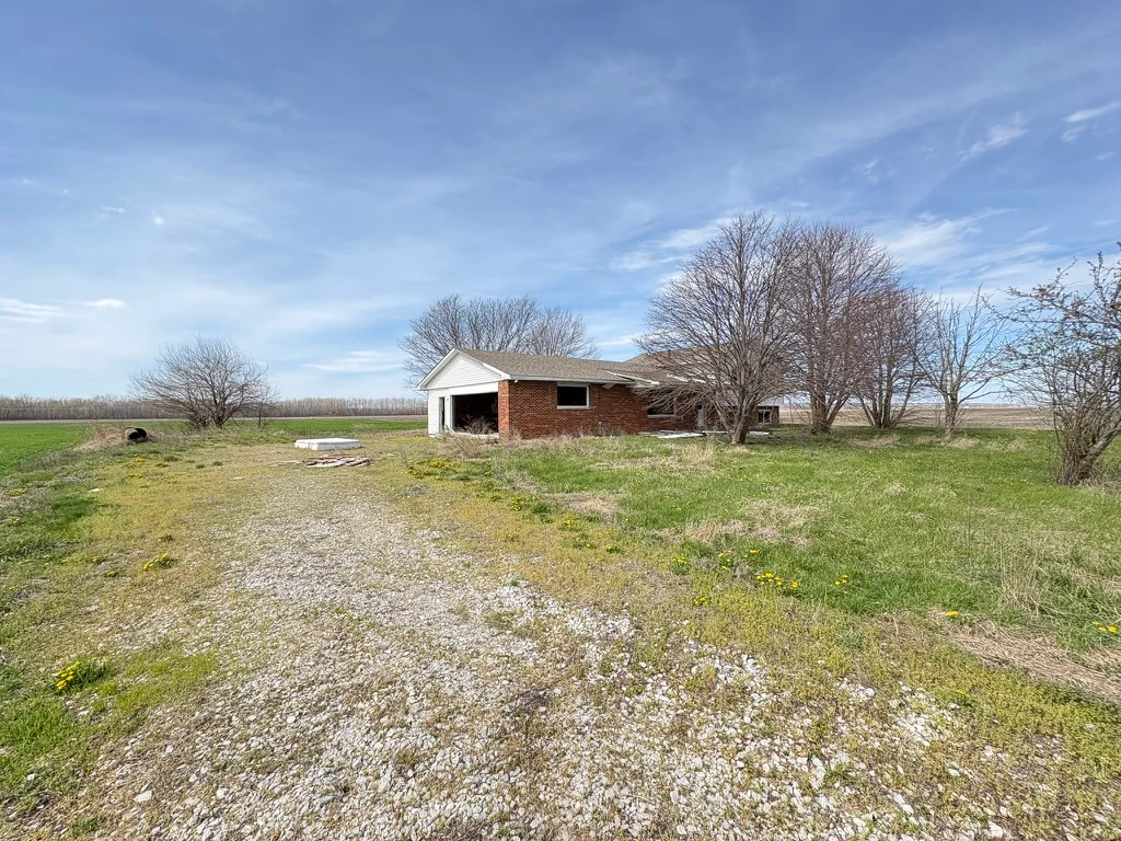 A wide view of the house and property from the front driveway.
