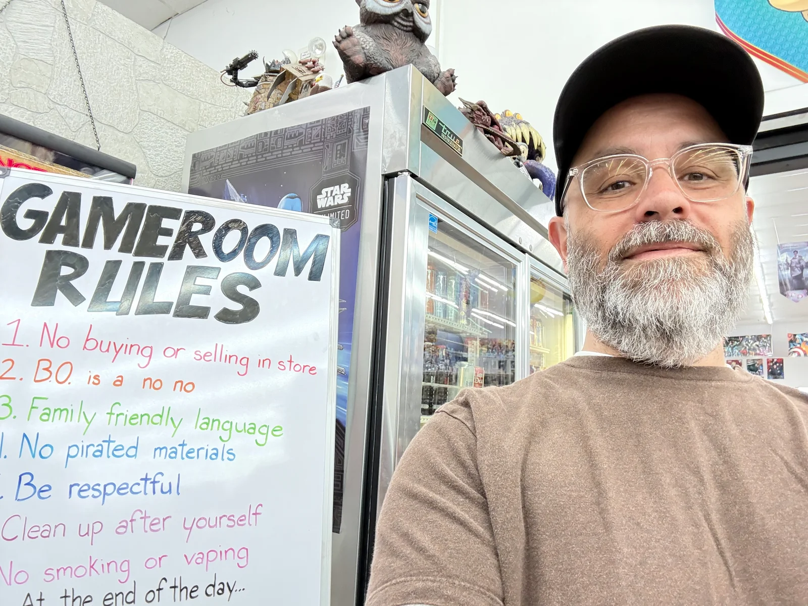 A selfie in front of the game room rules sign.