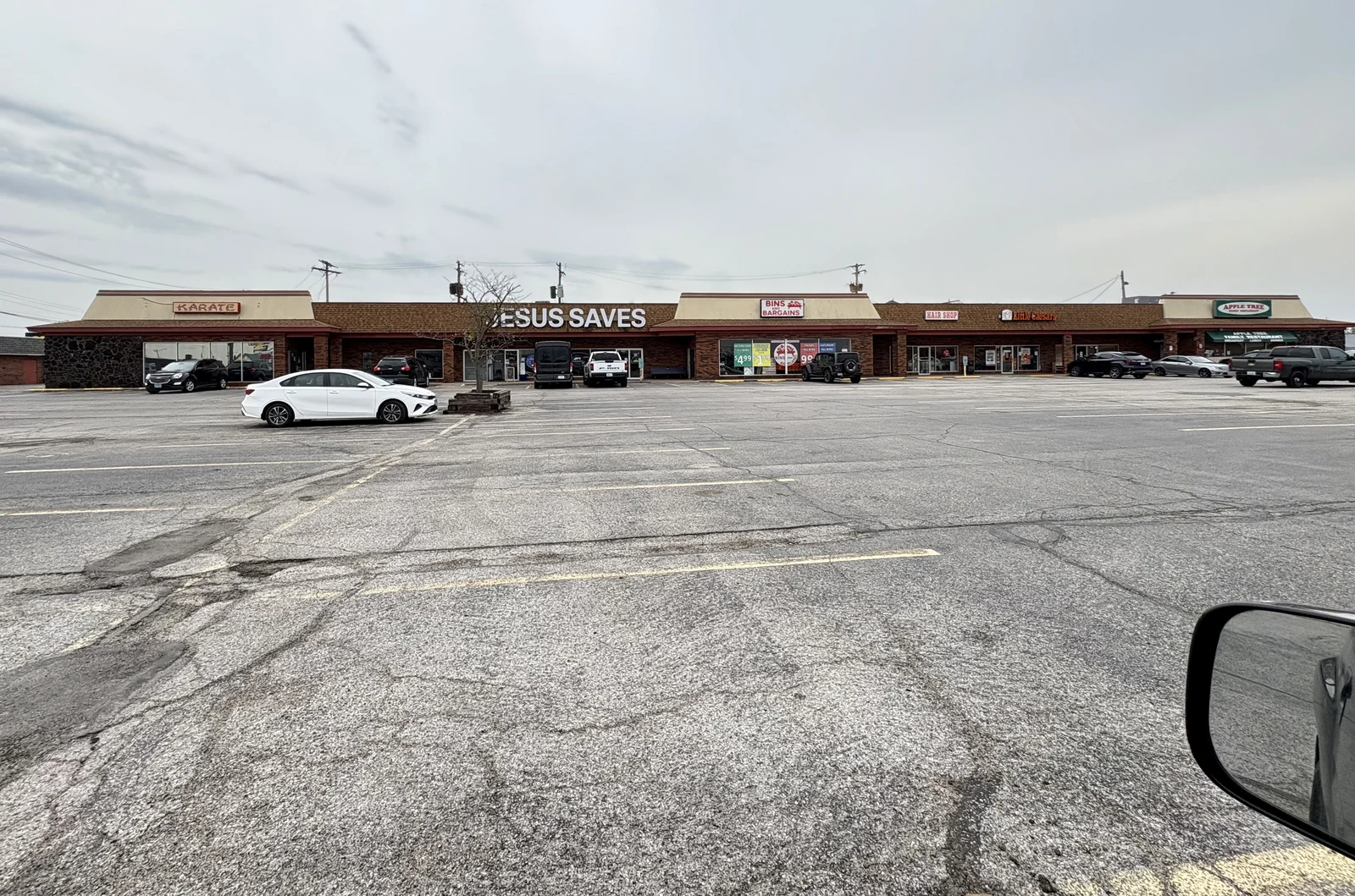 A pic out the window of the truck in Granite City, featuring a huge "Jesus Saves" sign and a strip mall.