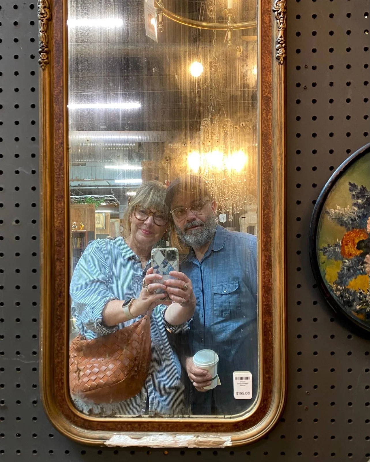 Mia and Mark take a selfie in an antique mirror.