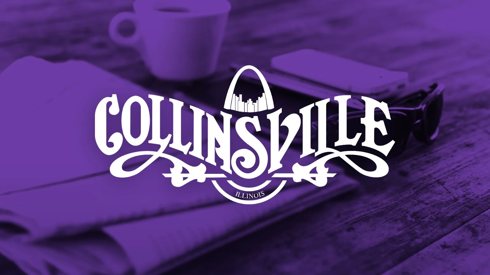 White "Collinsville" text with ornamental arch and "Illinois" beneath it, overlaid on a purple-tinted workspace with a mug and smartphone.